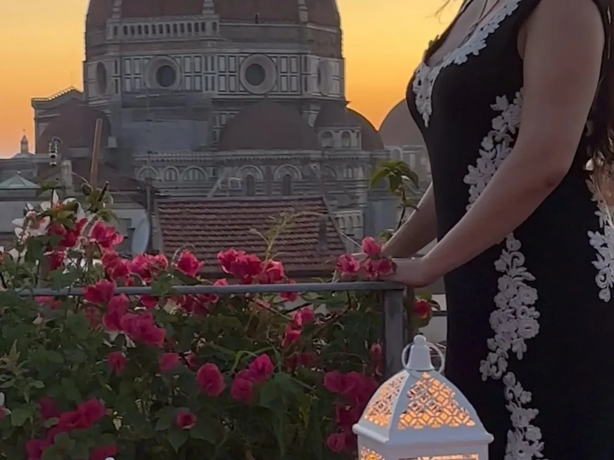 An opera singer performing at sunset beside the Florence Duomo