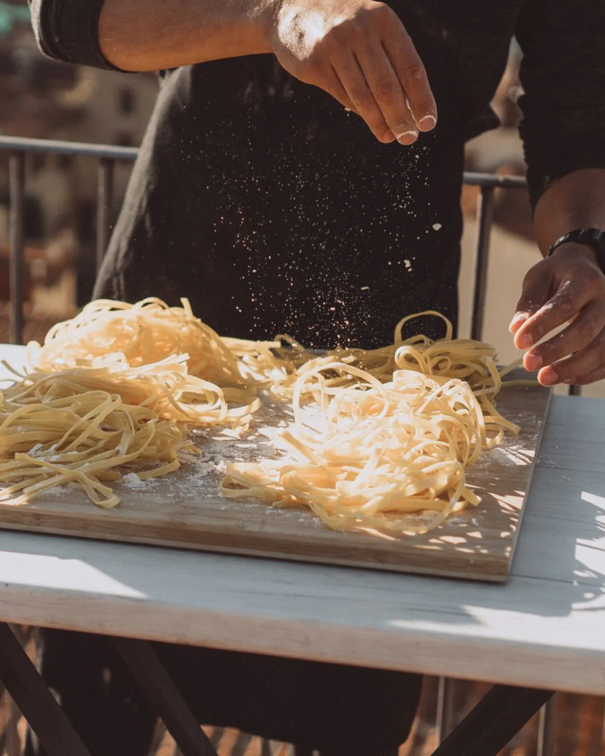 Guests learning to make fresh pasta on the rooftop