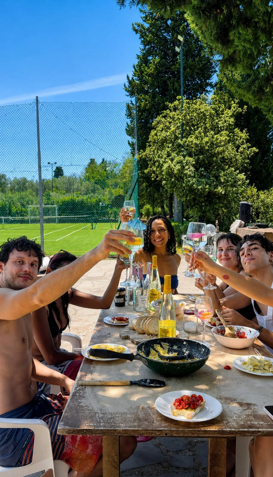 Guests raising glasses around an outdoor table at the private Florence villa