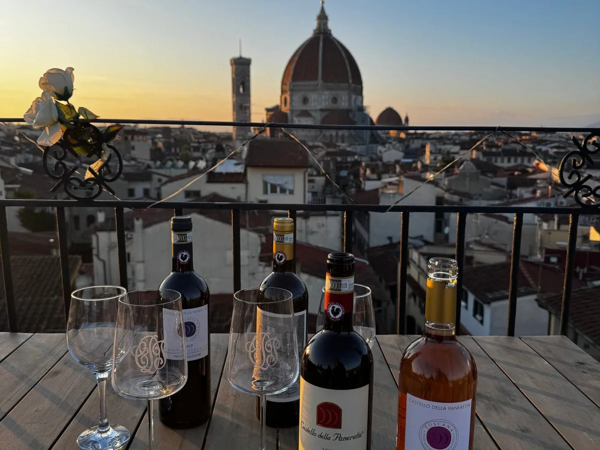 Tuscan wine set on a rooftop table overlooking the Duomo